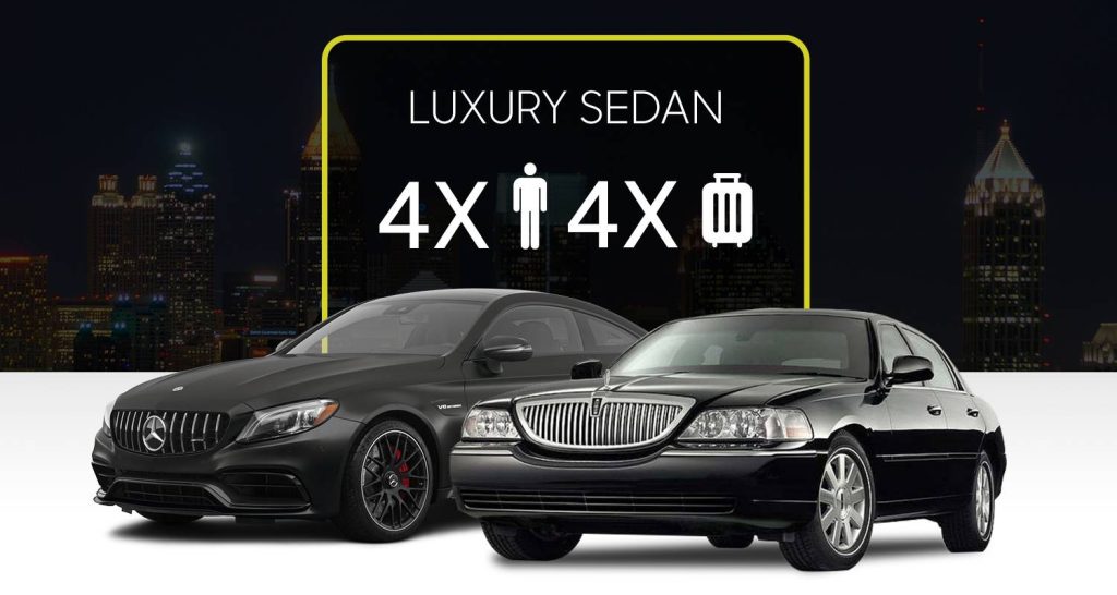 Two luxury black sedans with city skyline